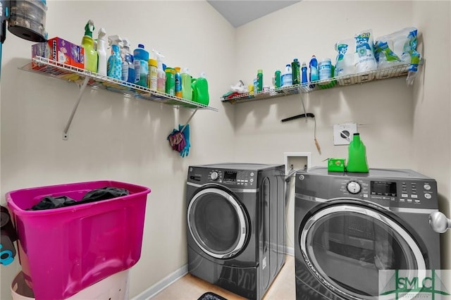 washroom with washer and clothes dryer, laundry area, and baseboards
