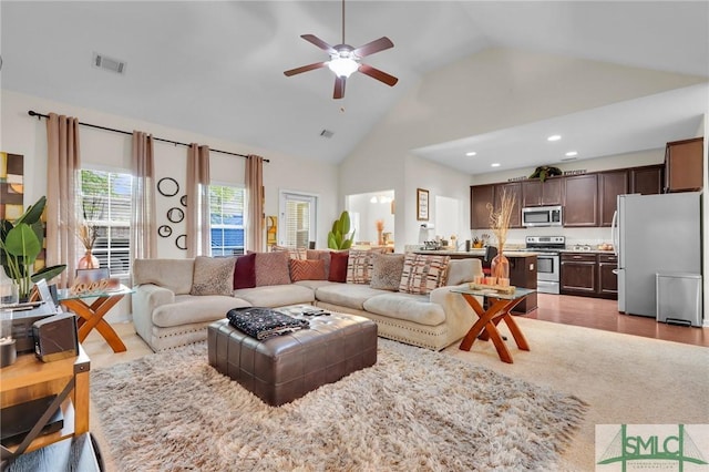 living room featuring high vaulted ceiling, ceiling fan, visible vents, and recessed lighting