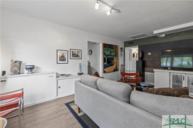 109 Seminole St, Savannah, GA 31406 - living room featuring visible vents, light wood-style floors, and a textured ceiling