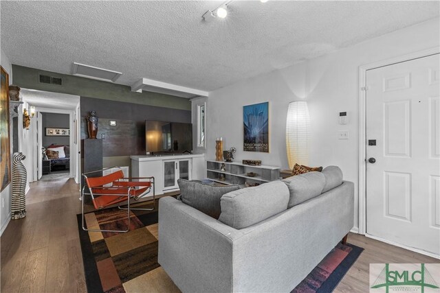 109 Seminole St, Savannah, GA 31406 - living area featuring visible vents, wood finished floors, and a textured ceiling