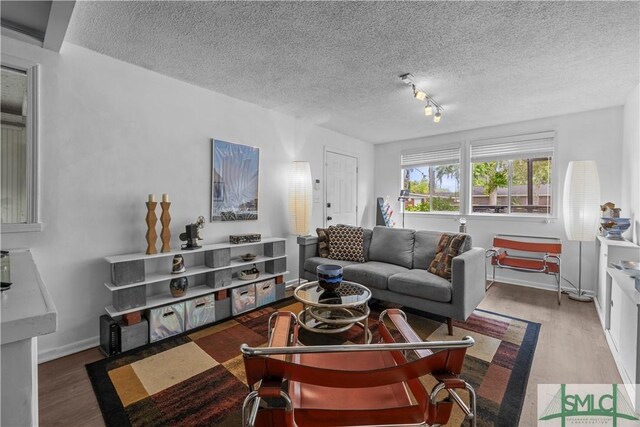 109 Seminole St, Savannah, GA 31406 - living area featuring baseboards, wood finished floors, and a textured ceiling