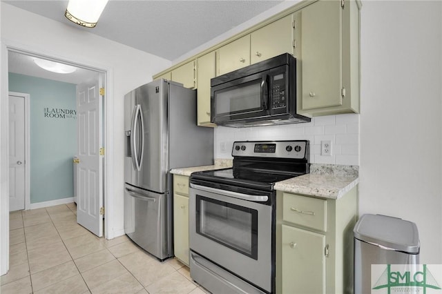 2 Finch Ct, Savannah, GA 31419 - kitchen with appliances with stainless steel finishes, cream cabinets, light countertops, tasteful backsplash, and light tile patterned floors