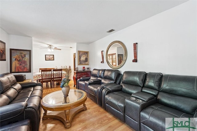 living area featuring visible vents, light wood-style flooring, and ceiling fan
