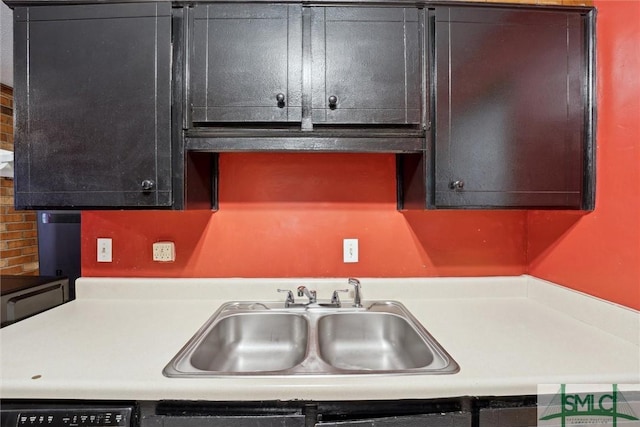 kitchen featuring a sink, light countertops, and dishwasher