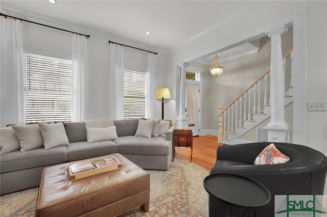 living room featuring ornamental molding, wood finished floors, stairway, recessed lighting, and decorative columns