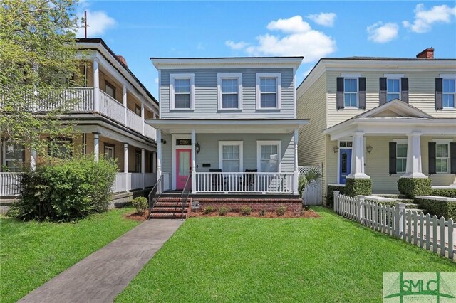 view of front of home with a porch and a front lawn
