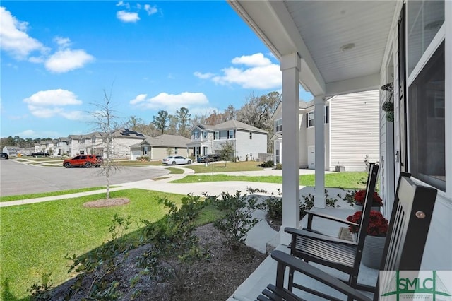 view of patio with covered porch and a residential view