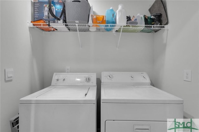 clothes washing area featuring laundry area and washing machine and clothes dryer