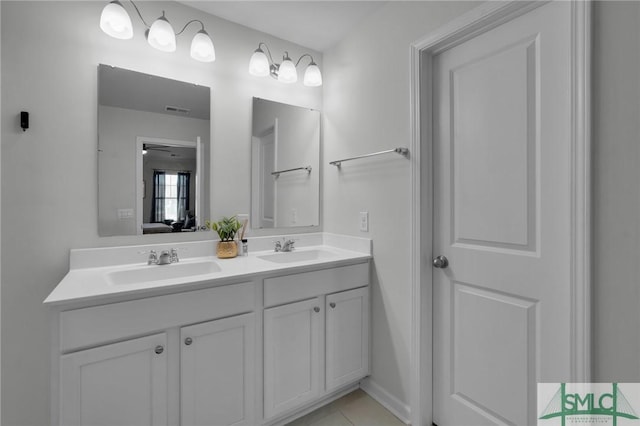full bath featuring double vanity, a sink, tile patterned flooring, and visible vents