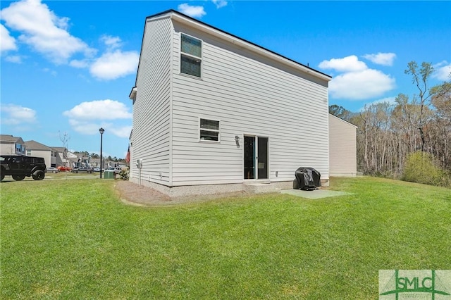 rear view of house featuring a lawn