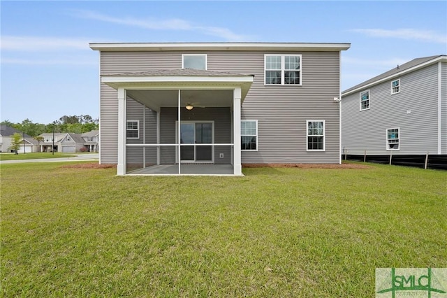 back of property featuring a yard and a sunroom
