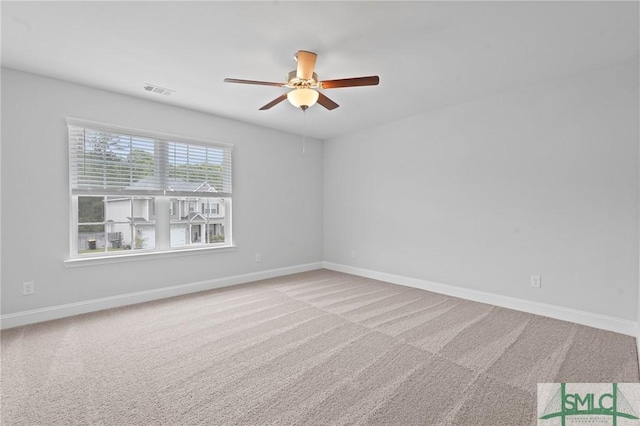 unfurnished room featuring carpet flooring, visible vents, baseboards, and ceiling fan