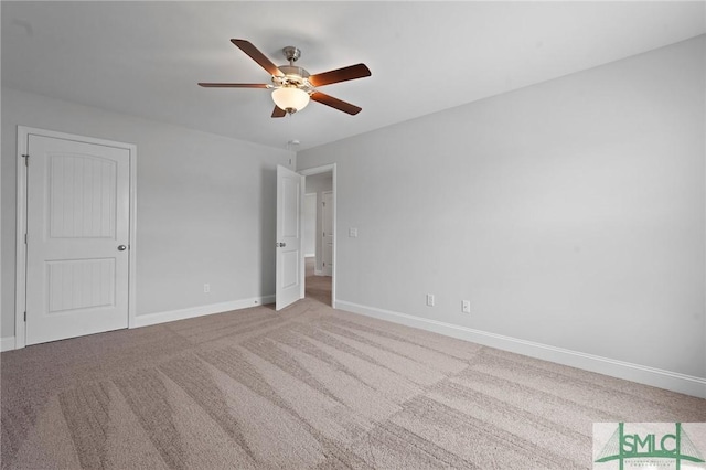 unfurnished bedroom featuring carpet flooring, baseboards, and a ceiling fan