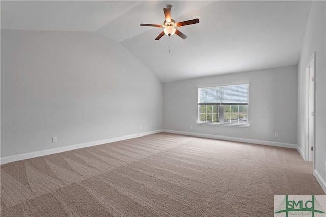unfurnished room featuring carpet flooring, baseboards, a ceiling fan, and lofted ceiling