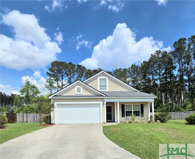 view of front of house with driveway, fence, and a front lawn