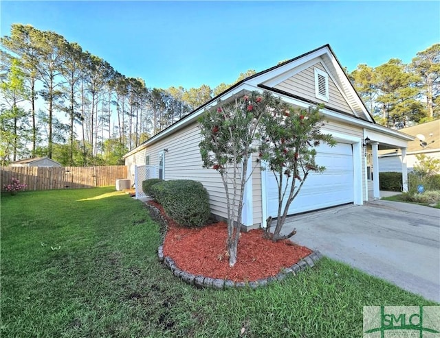 view of side of property with a lawn, a garage, concrete driveway, fence, and central air condition unit
