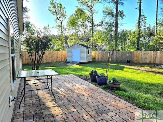 view of patio with a fenced backyard, a storage unit, and an outdoor structure