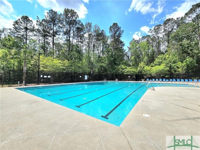 pool with fence and a patio