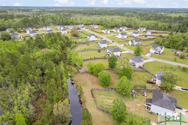 drone / aerial view featuring a wooded view