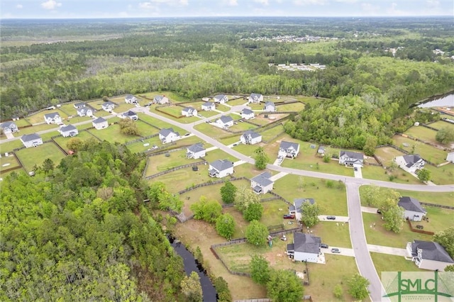 drone / aerial view with a view of trees and a residential view
