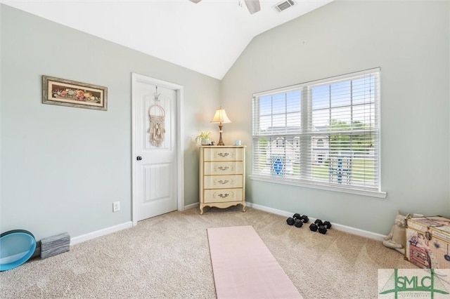 interior space with light carpet, visible vents, baseboards, and lofted ceiling