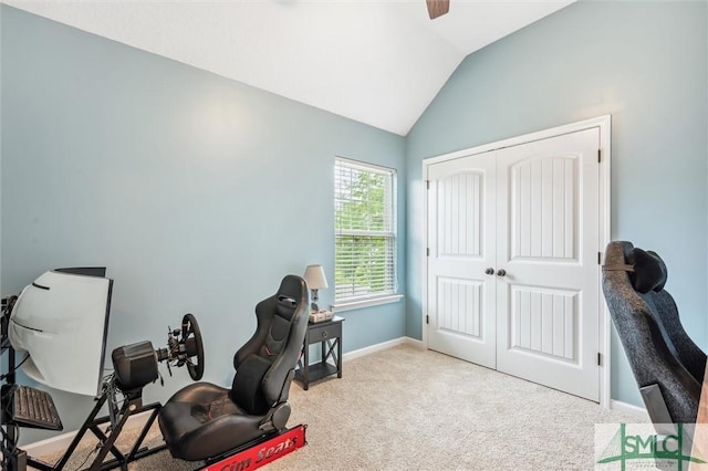 carpeted office space with baseboards and lofted ceiling