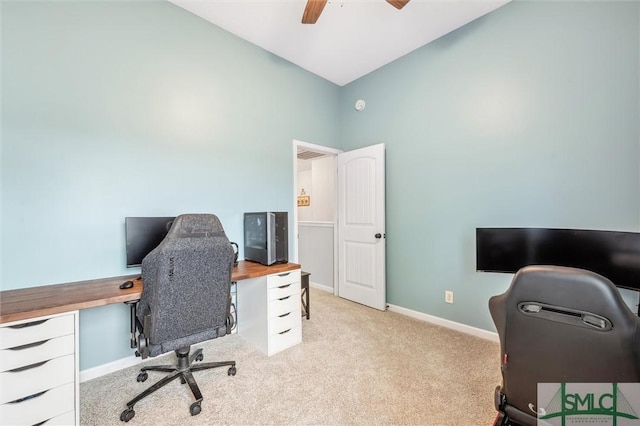 office space featuring baseboards, a ceiling fan, light colored carpet, and vaulted ceiling
