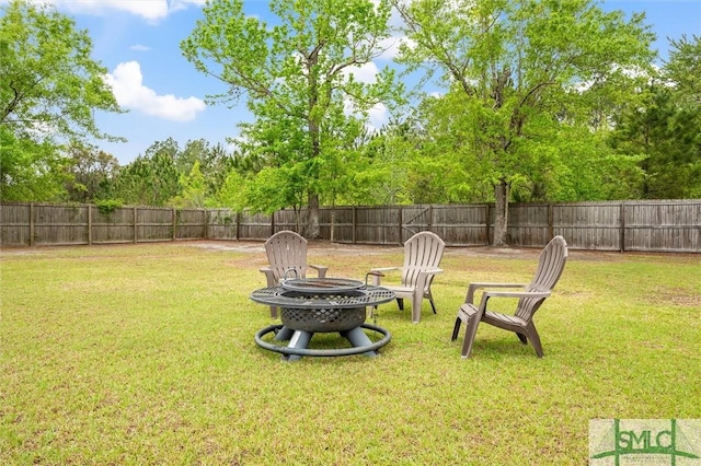 view of yard featuring an outdoor fire pit and a fenced backyard