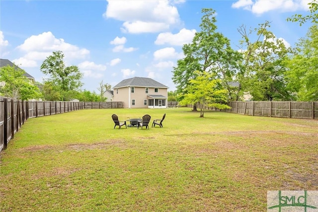 view of yard featuring a fire pit and a fenced backyard