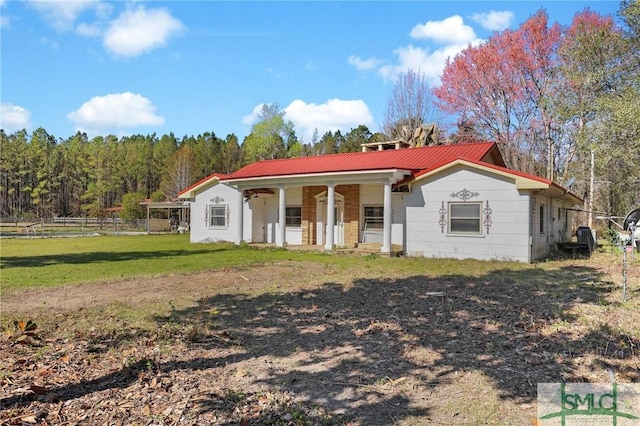 1505 Wilson Rd, Brooklet, GA 30415 - view of front of house with a porch, metal roof, fence, and a front yard