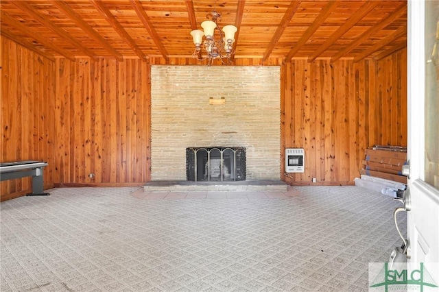 1505 Wilson Rd, Brooklet, GA 30415 - unfurnished living room with wood walls, an inviting chandelier, and heating unit
