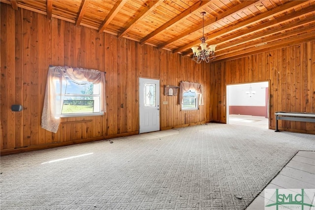 1505 Wilson Rd, Brooklet, GA 30415 - interior space featuring a chandelier, carpet flooring, wood walls, beamed ceiling, and wooden ceiling