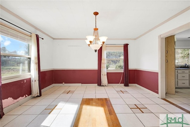 1505 Wilson Rd, Brooklet, GA 30415 - unfurnished dining area featuring an inviting chandelier, ornamental molding, tile patterned floors, wainscoting, and a sink