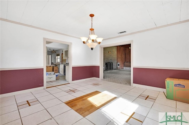 1505 Wilson Rd, Brooklet, GA 30415 - tiled spare room with a chandelier, visible vents, ornamental molding, and a wainscoted wall