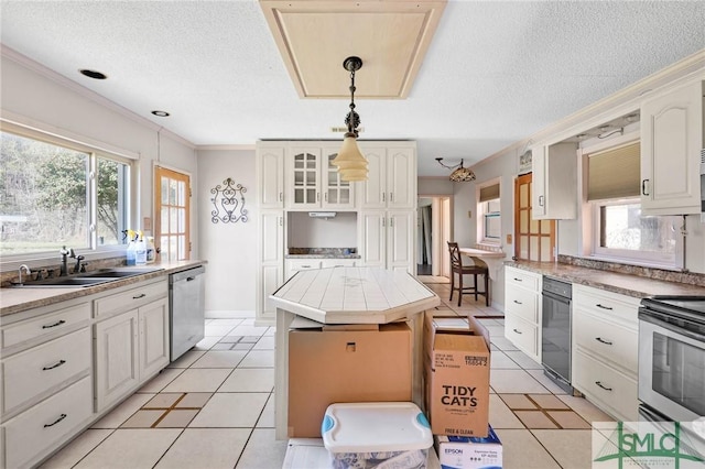 1505 Wilson Rd, Brooklet, GA 30415 - kitchen featuring light tile patterned floors, a center island, decorative light fixtures, a sink, and appliances with stainless steel finishes