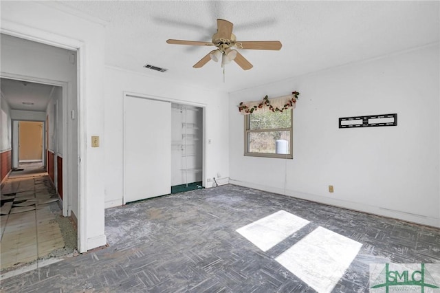 1505 Wilson Rd, Brooklet, GA 30415 - unfurnished bedroom with baseboards, a closet, a textured ceiling, visible vents, and ceiling fan