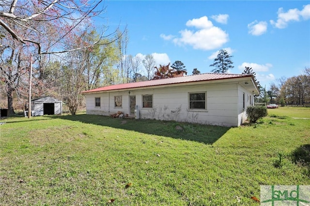 1505 Wilson Rd, Brooklet, GA 30415 - exterior space featuring a yard, metal roof, a chimney, and an outbuilding