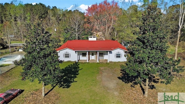 1505 Wilson Rd, Brooklet, GA 30415 - view of front of house featuring a wooded view, a front lawn, metal roof, and a porch