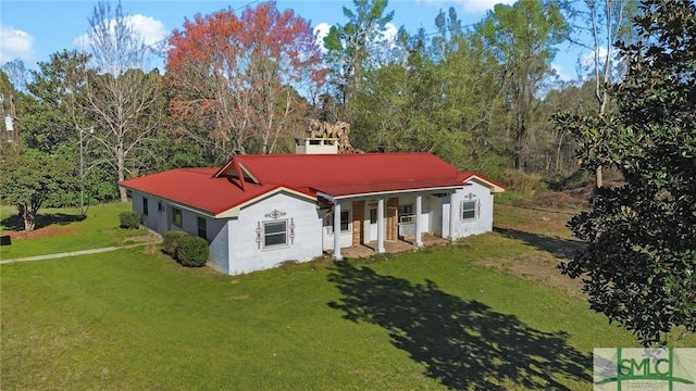 1505 Wilson Rd, Brooklet, GA 30415 - view of front of house with covered porch, a front yard, and metal roof