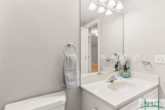 half bathroom with toilet and vanity