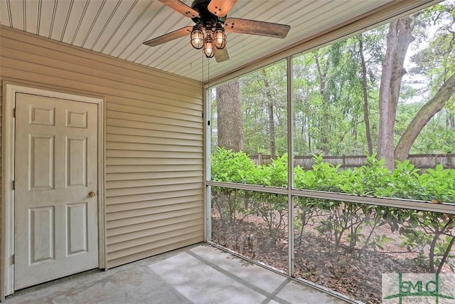 unfurnished sunroom with a ceiling fan