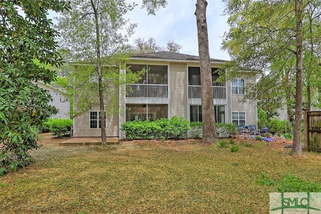 rear view of house with a lawn