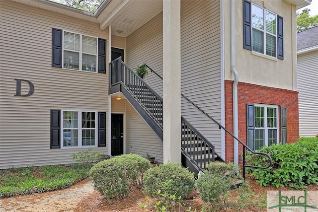 doorway to property with brick siding