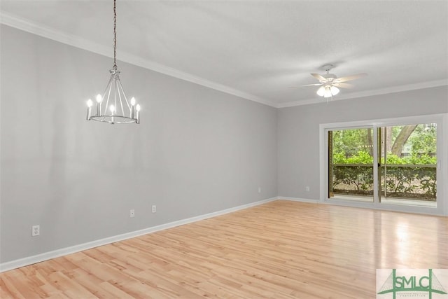 empty room with ceiling fan with notable chandelier, light wood-type flooring, baseboards, and crown molding