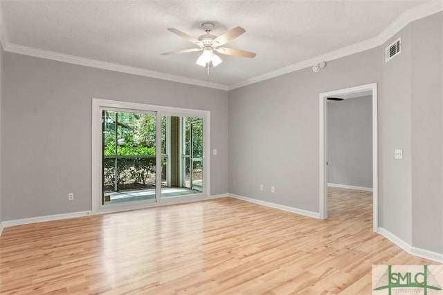 spare room with baseboards, visible vents, light wood-type flooring, and a ceiling fan