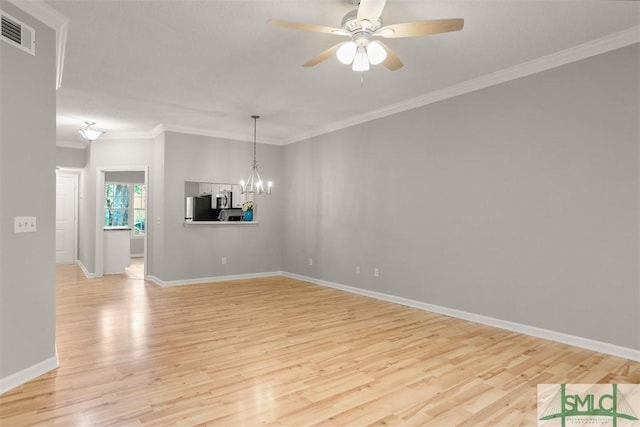 interior space with baseboards, ornamental molding, light wood-style floors, visible vents, and ceiling fan with notable chandelier