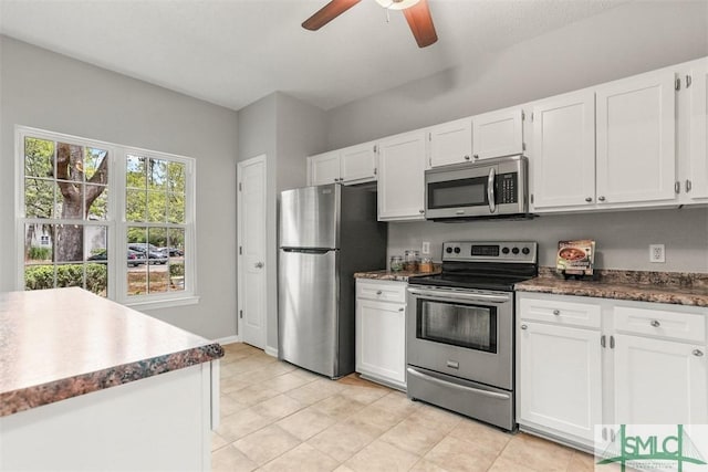 kitchen with dark countertops, ceiling fan, white cabinetry, and appliances with stainless steel finishes