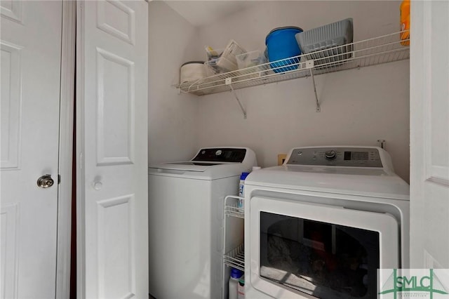 clothes washing area featuring independent washer and dryer and laundry area