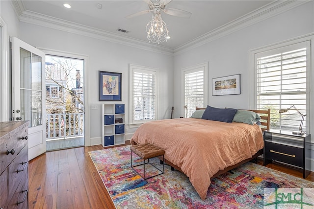 bedroom featuring access to outside, ornamental molding, visible vents, baseboards, and hardwood / wood-style flooring