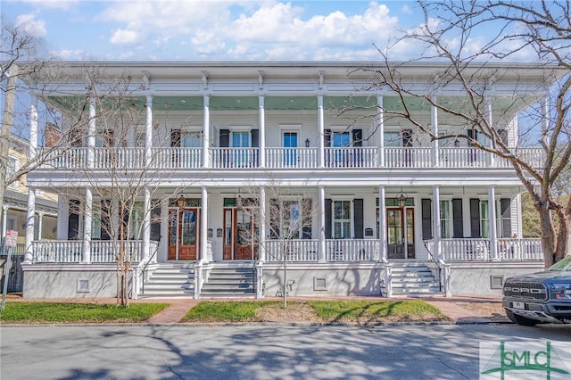 view of front of house with a porch, crawl space, and a balcony